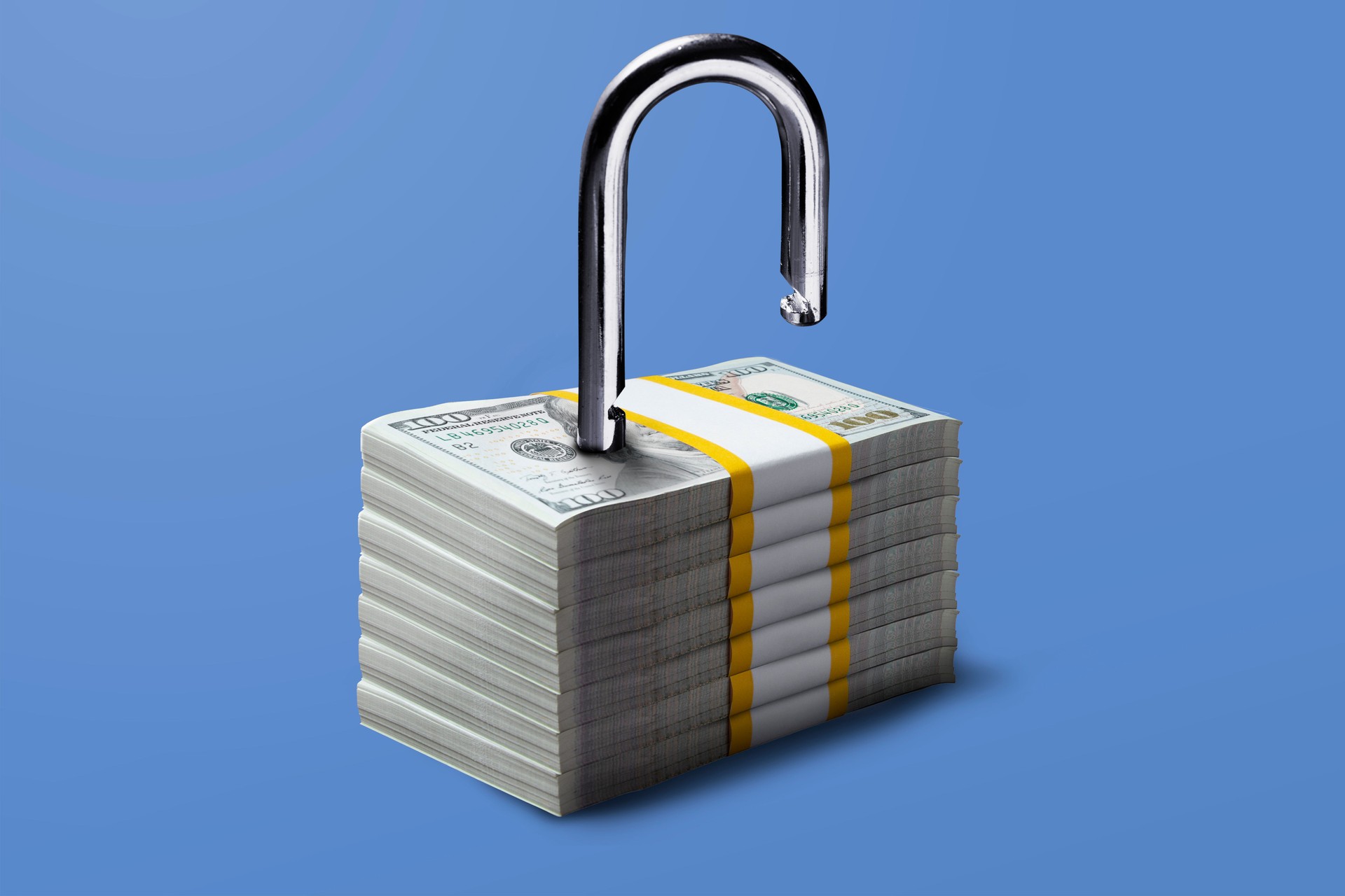 Financial freedom concept. Padlock on stacks of 100 US Dollar bill